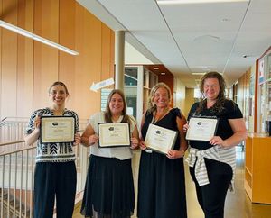 Teachers with their certificates